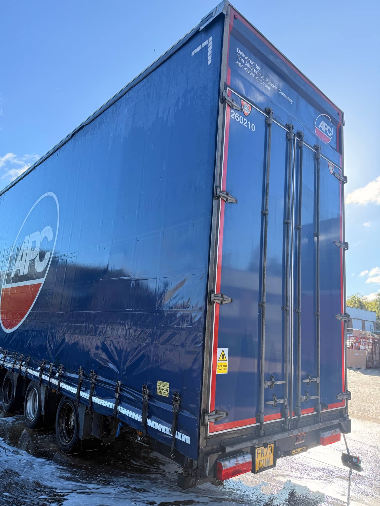 Clean blue curtainside trailer after mobile washing