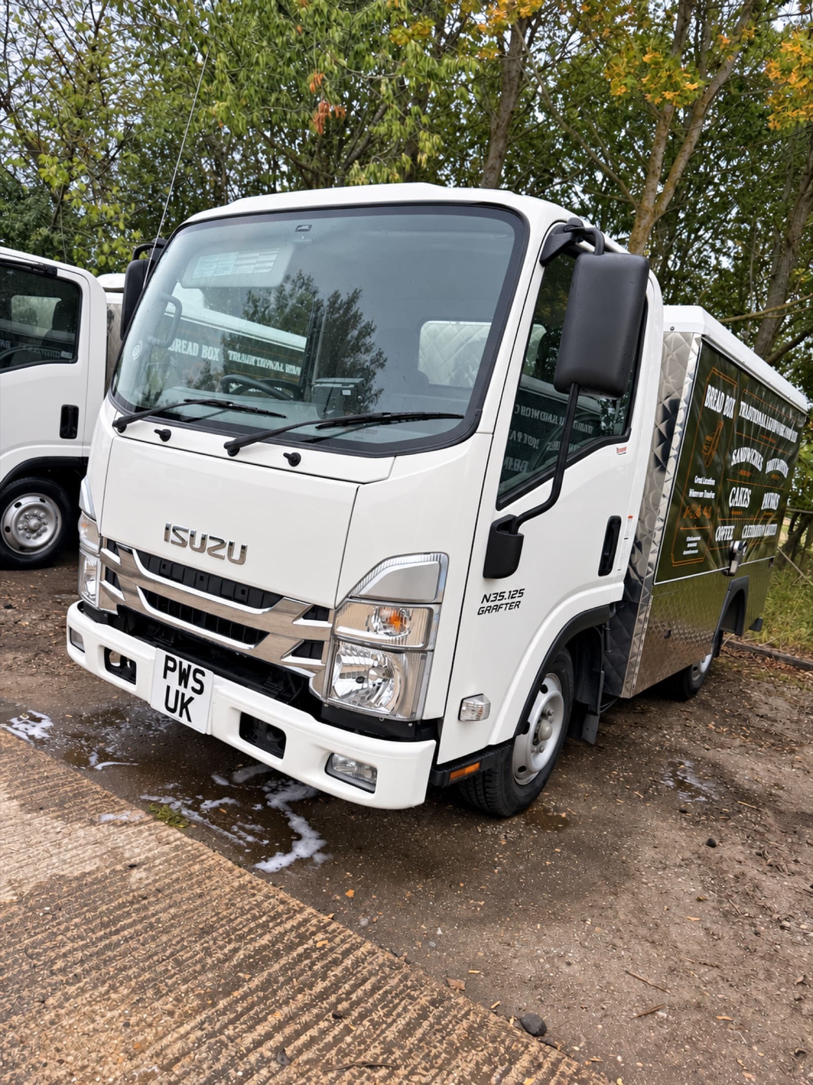 Freshly cleaned white commercial vehicle following a mobile exterior wash