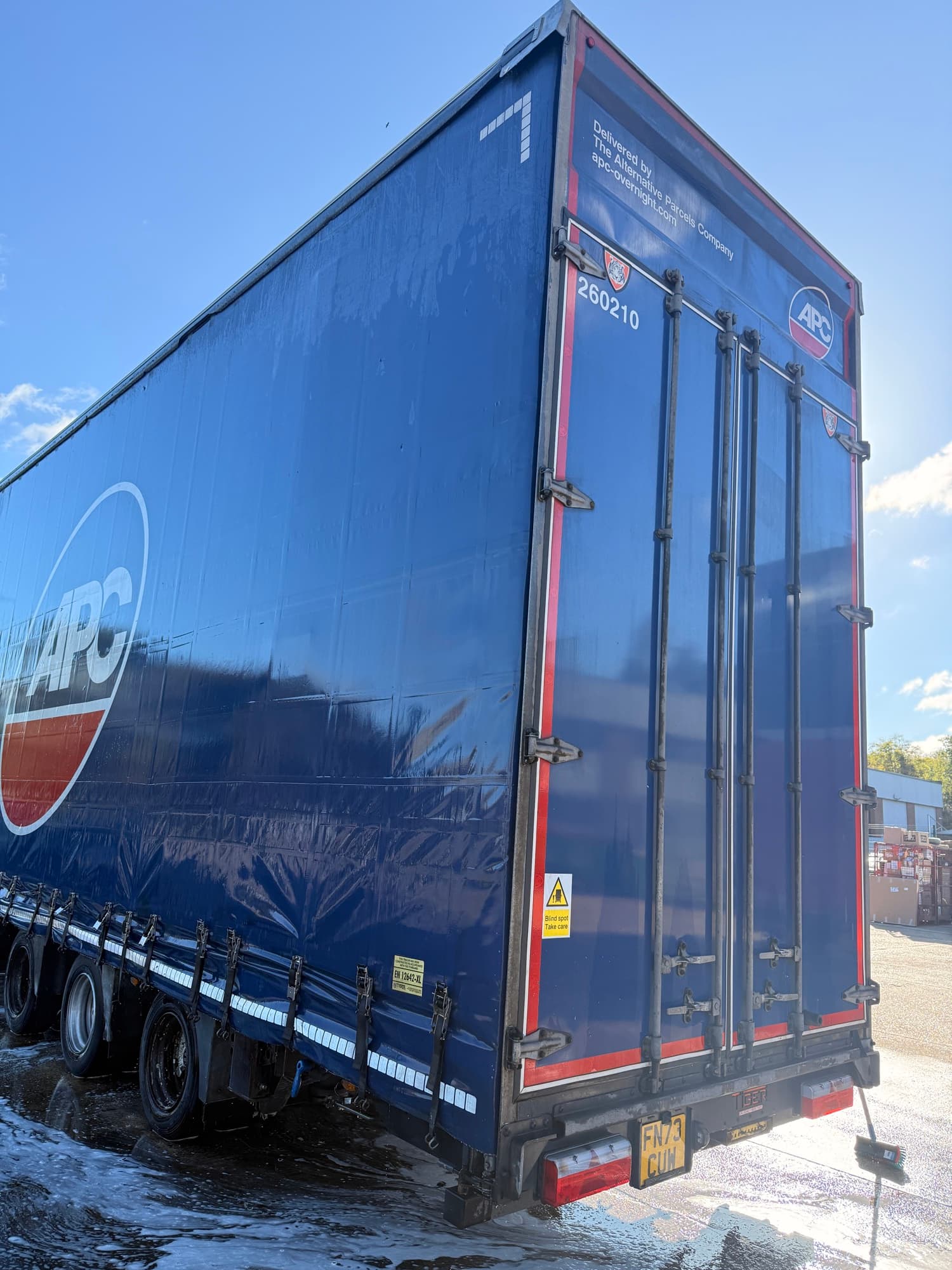 Clean blue curtainside trailer following a PWS wash