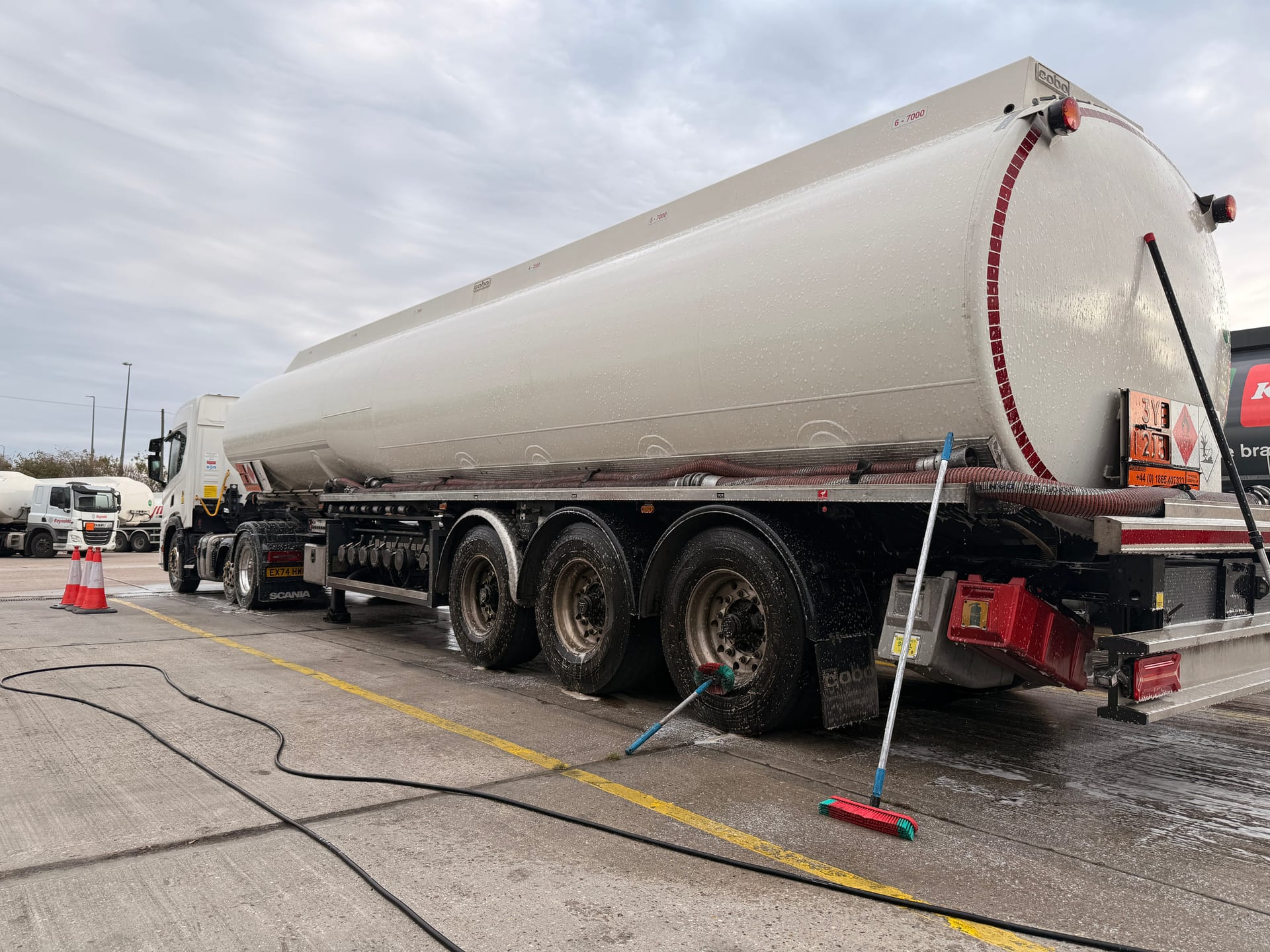 Tanker exterior covered with cleaning foam during a wash