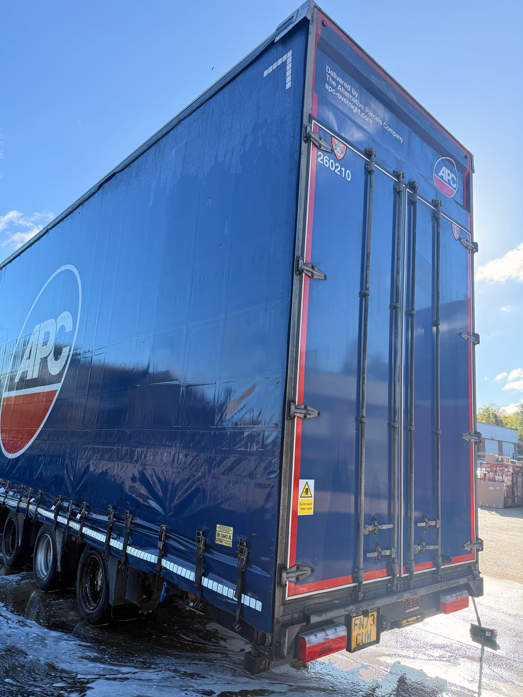 Clean blue commercial trailer following exterior washing