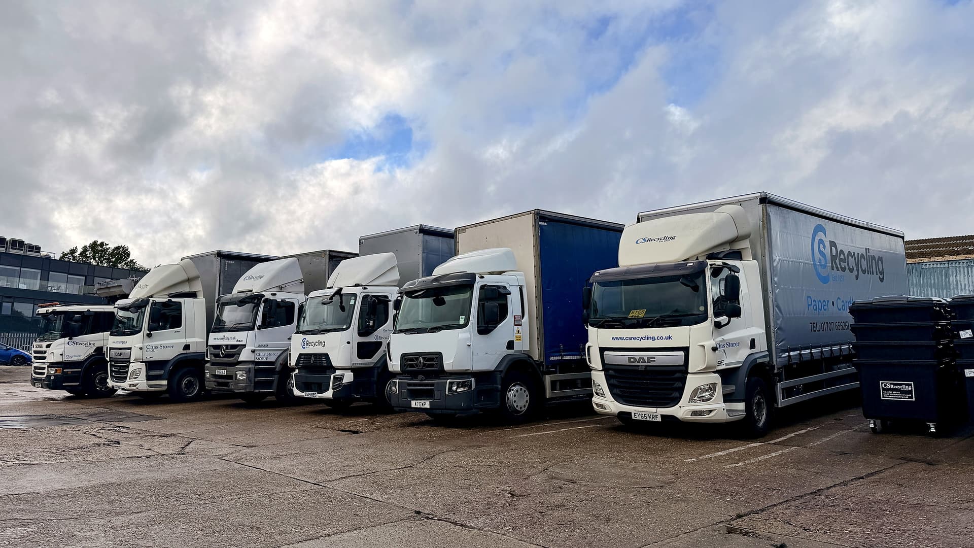 Line of clean commercial delivery trucks at a depot