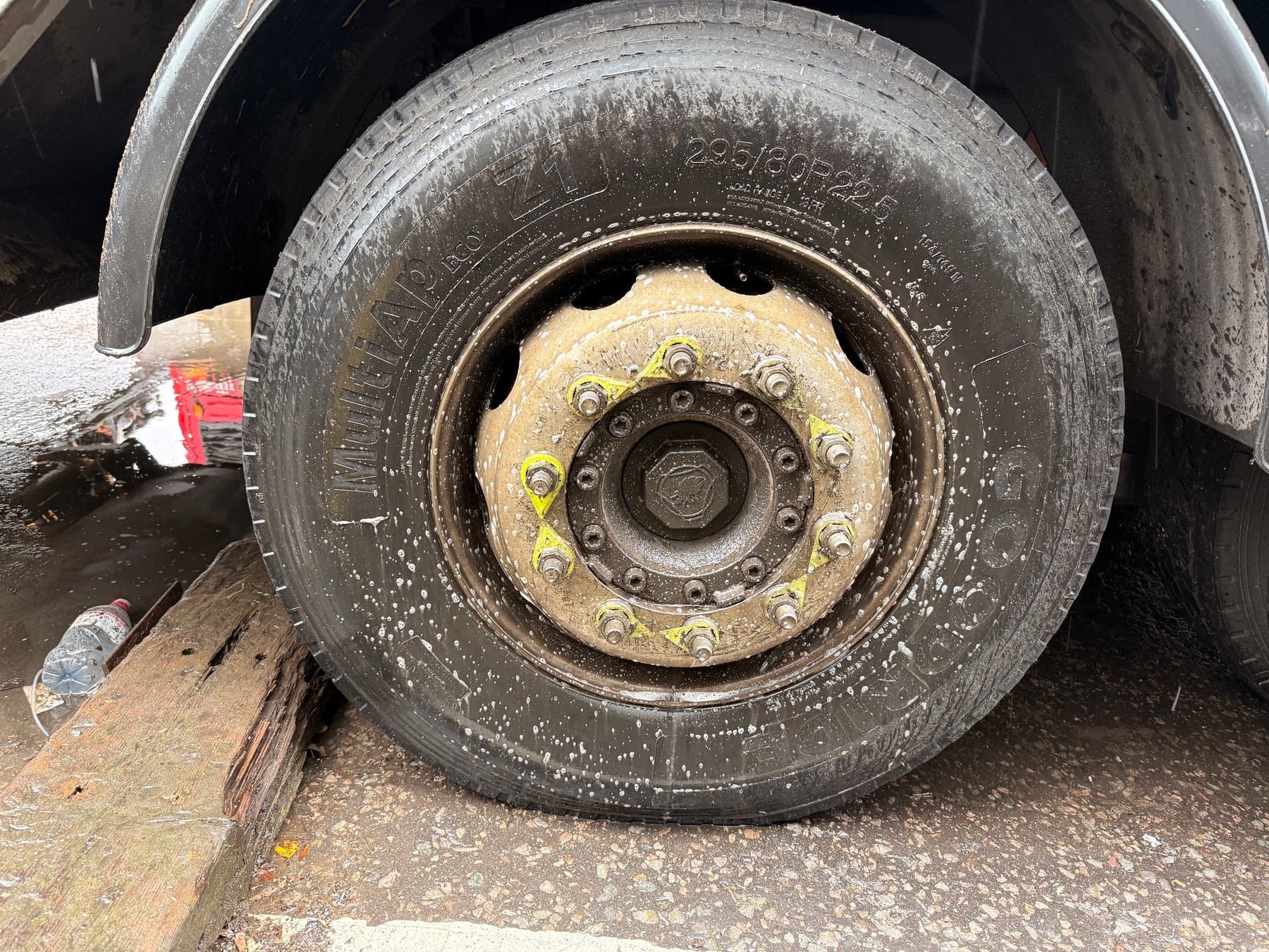 Built-up road dirt on an HGV wheel during cleaning